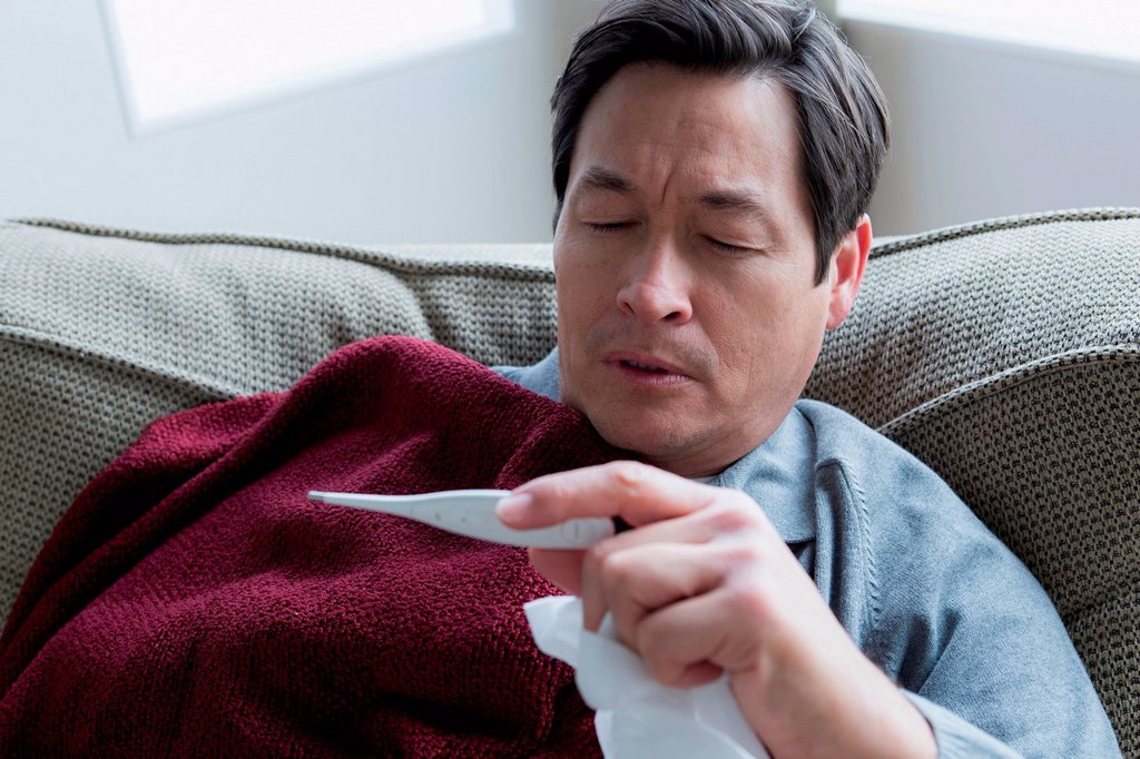 MATURE MAN TAKING TEMPERATURE