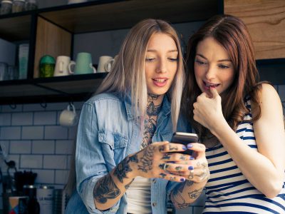 Women looking at smartphone together