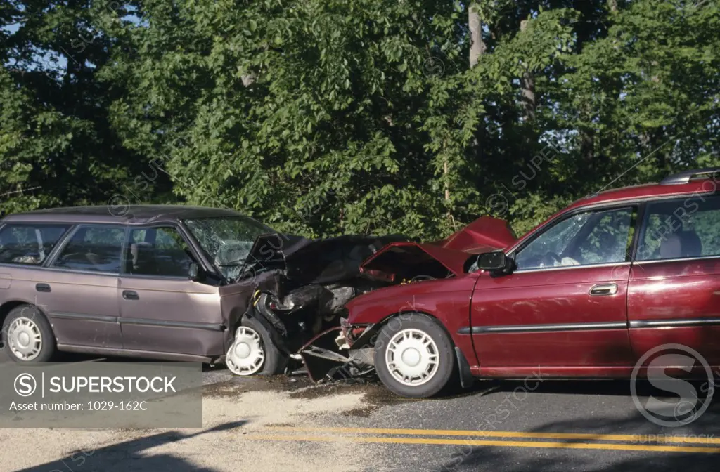 Two damaged cars on the road