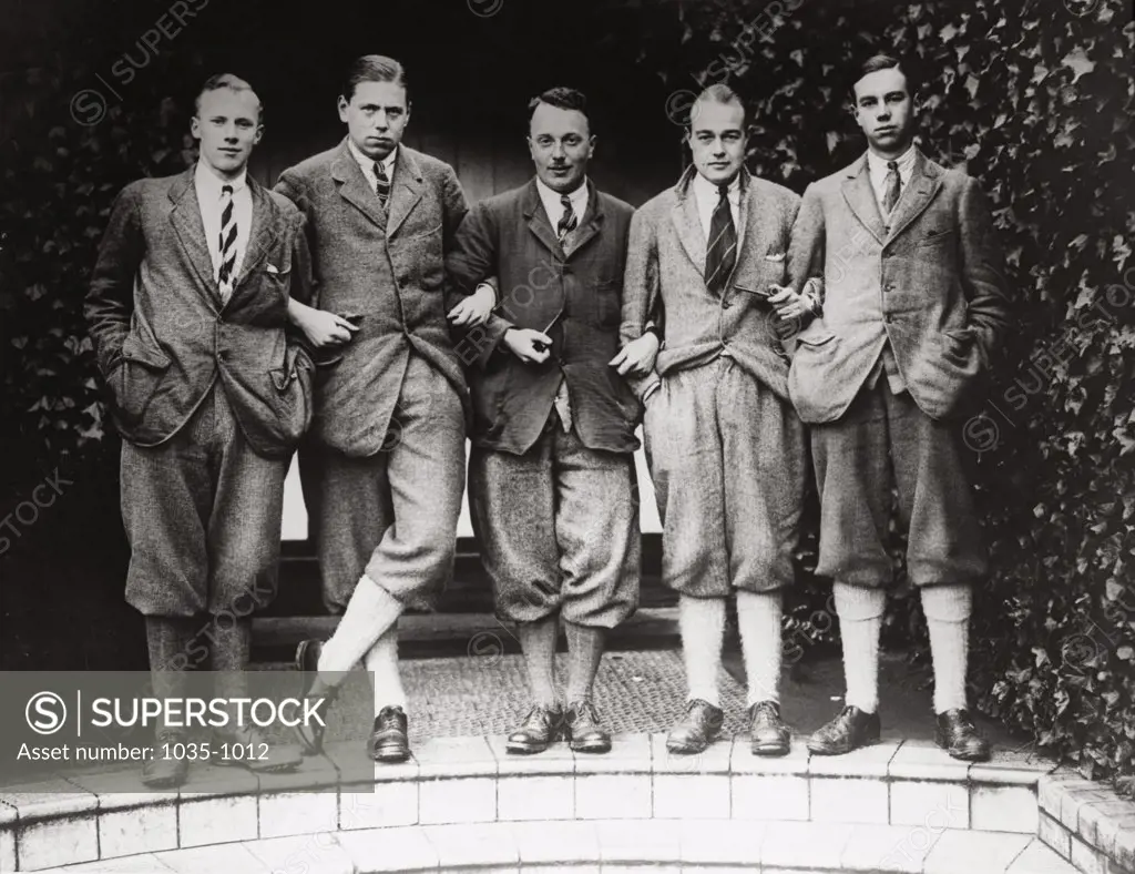 Portrait of five men posing together