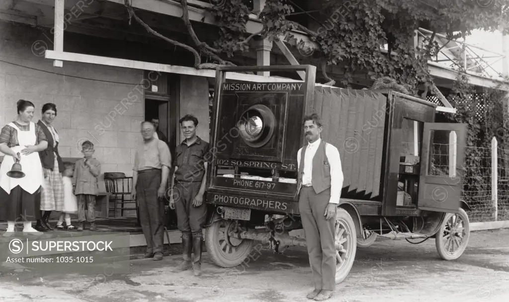 Family standing near a camera truck