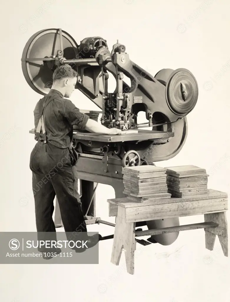 Mid adult man working on a machine in a factory
