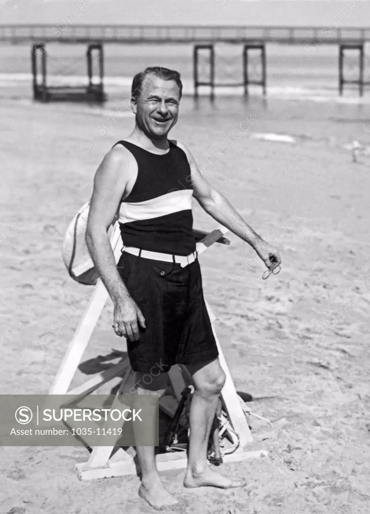 Palm Beach, Florida:   January 6, 1927. Harry Dunn of New York, and president of the Fisk Rubber Company enjoys the warm winter sands of Palm Beach.©Underwood Archives