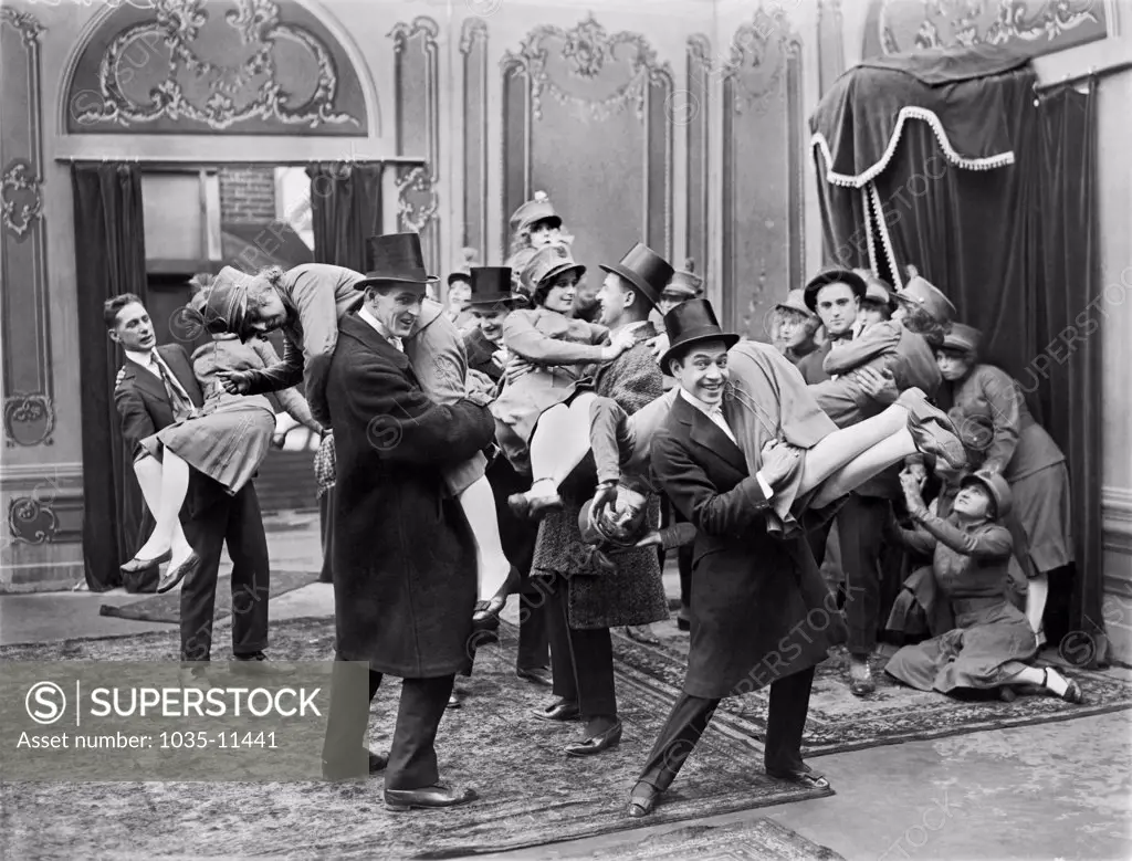 Hollywood, California:  c. 1918. A film still from an early silent movie featuring a raucous party scene.