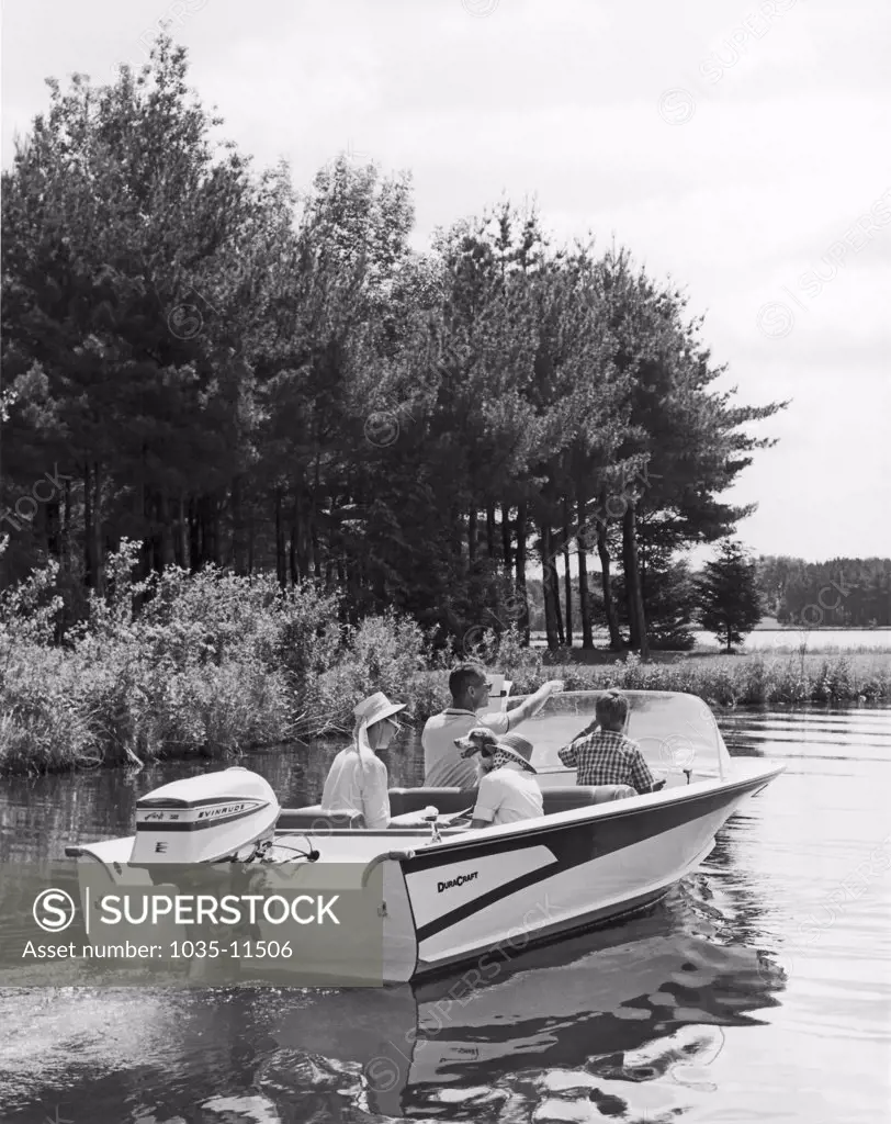 United States   c. 1960 A family and their dog enjoy a boat ride on a lake
