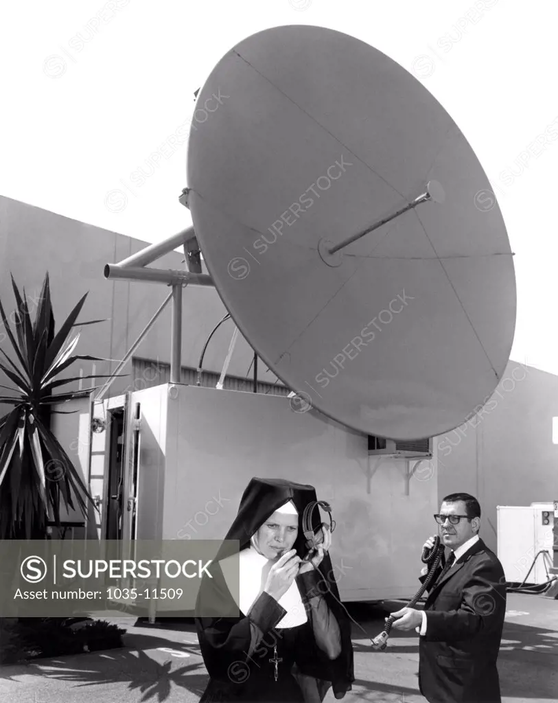 El Segundo, California:  August 6, 1968 This mobile TV satellite gorund station will be installed in Bogota, Columbia to transmit live color television coverage of Pope Paul VI's visit there later this month. Here it is being demonstrated to Sister Cecilia Louise, the president of Mount St. Mary's college in Los Angeles.