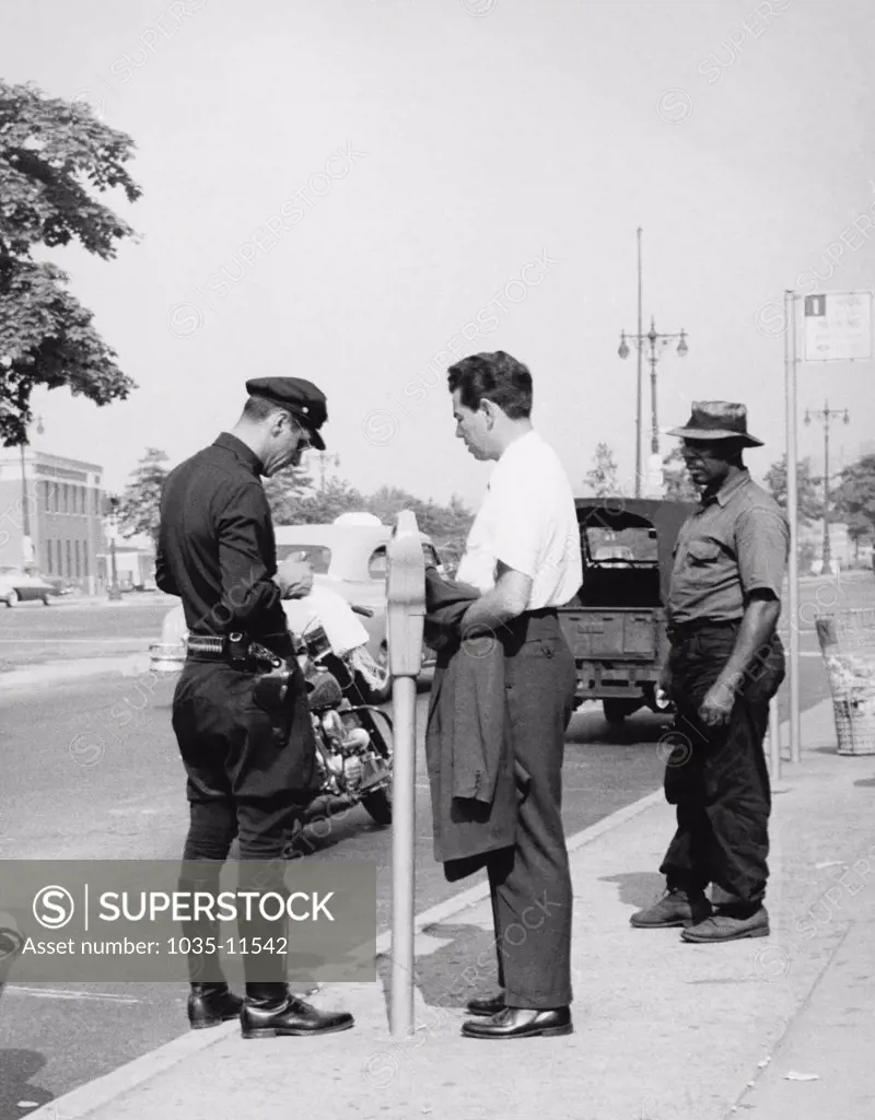 United States:   1955.  A man gets a parking ticket for an expired meter.