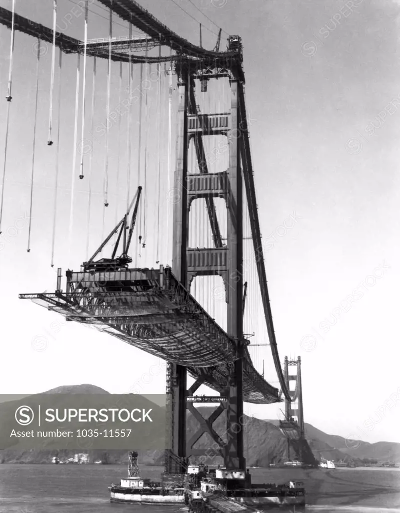 San Francisco, California:   October 16, 1936. The Golden Gate Bridge under construction, with the roadbed being suspended from the cables.