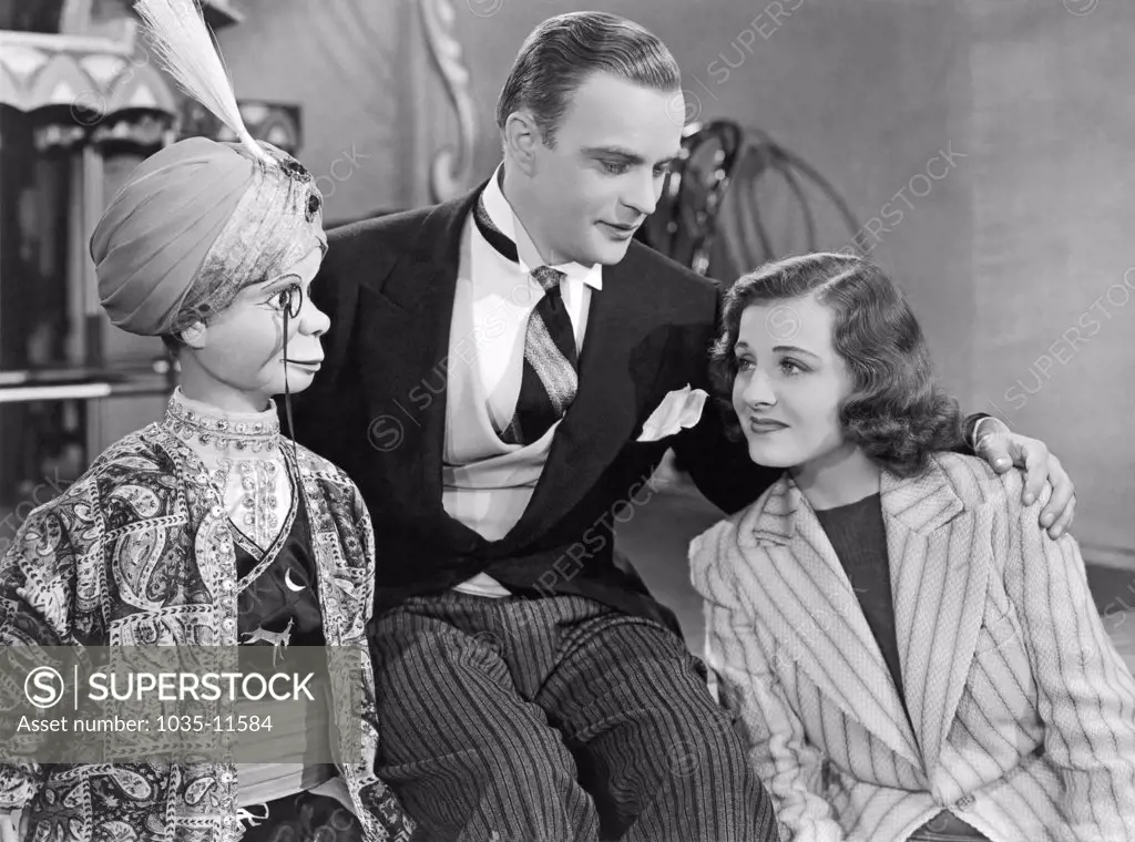 Hollywood, California:  1939. Edgar Bergen and Charlie McCarthy with Constance Moore in the film,'You Can't Cheat An Honest Man'.