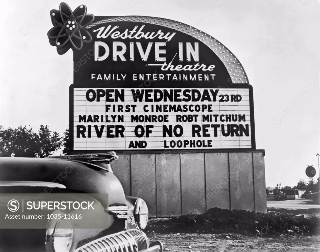 Westbury, New York:  1954. Drive-in theater sign advertising 'River Of No Return', starring Robert Mitchum and Marilyn Monroe.