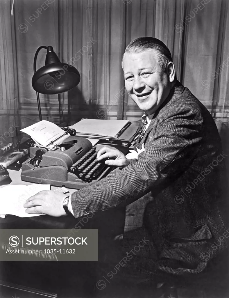 New York, New York:  c.1948. A New York Telegram & Sun newspaper reporter at work on his Underwood typewriter.