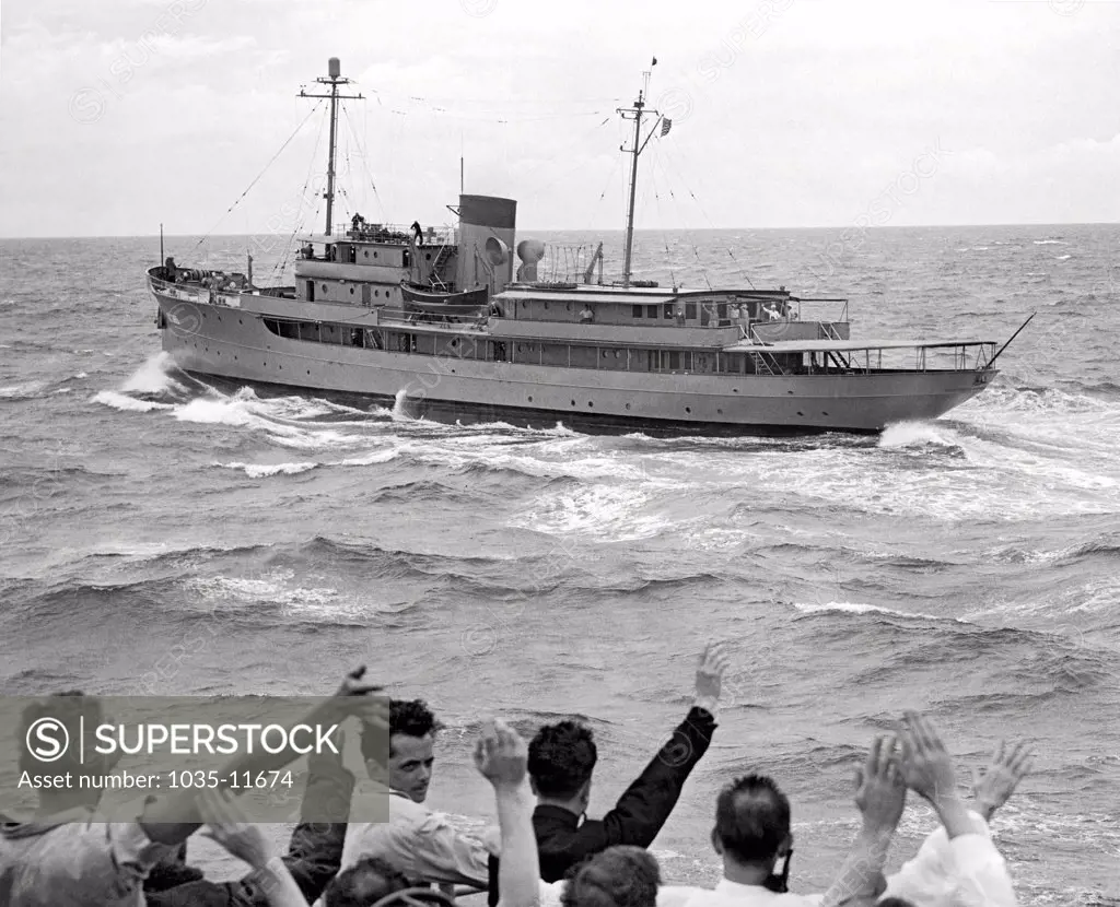 Atlantic Ocean:  August, 1946. The Presidential yacht, 'Williamsburg', has rough going in choppy seas as it heads to Bermuda with President Truman aboard. Reporters are waving to the President from the escort ship, the USS Weiss.