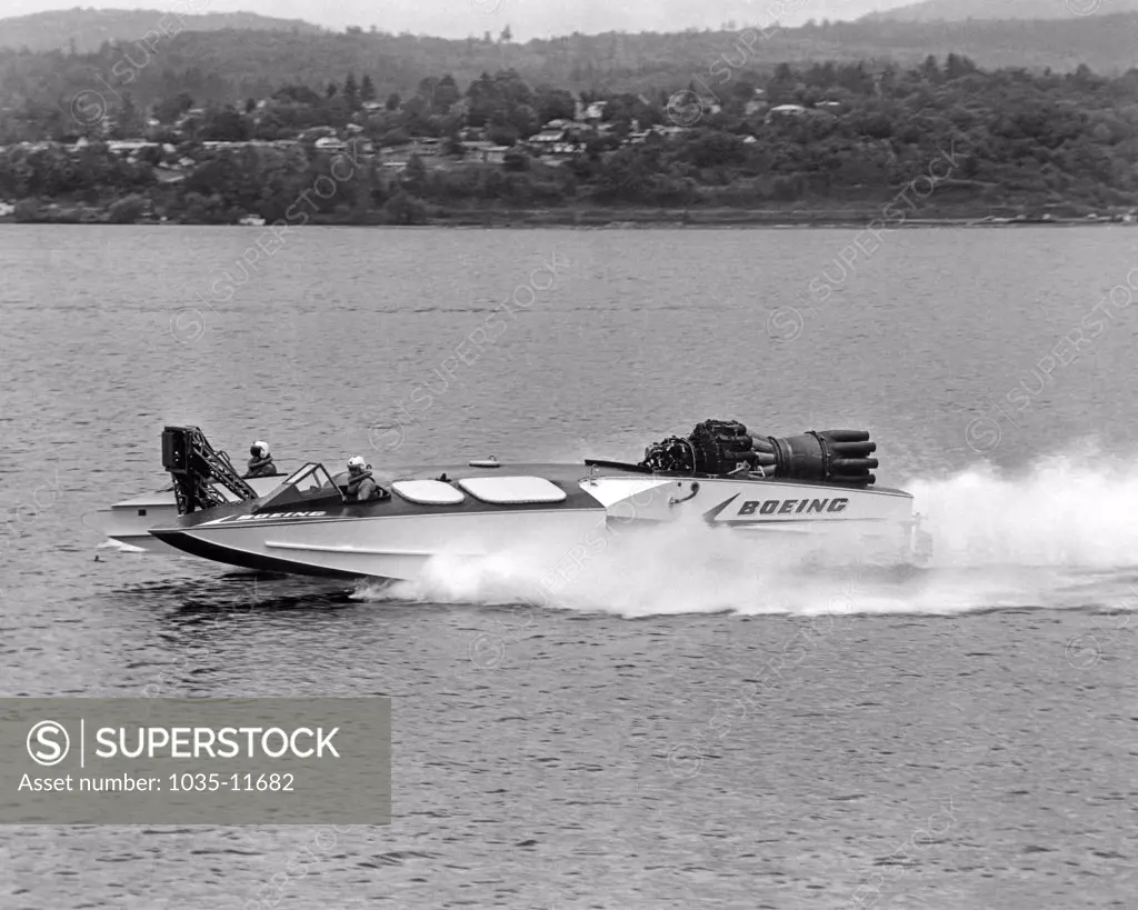 Seattle, Washington:   c. 1961. The Aqua-Jet on Lake Washington, a jet engine powered experimental speed boat made by Boeing. It is 38 feet long with a 17 foot beam, can reach speeds of 100 knots (115 mph), and is powered by an Allison J-3 turbojet with 4600 pounds of thrust.