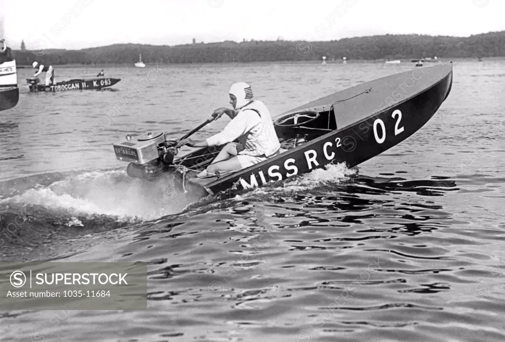 Lake Templin, Germany:  1926. Helen Hentschel of New York wins the Class B Outboard Races on Lake Templin in Germany, with an  average speed of 28.7 mph.