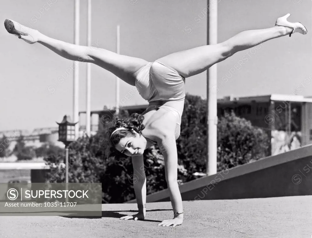 San Francisco, California:   1939. Sally Rand combines a hand stand with the splits at the Golden Gate International Exhibition on Treasure Island in San Francisco.