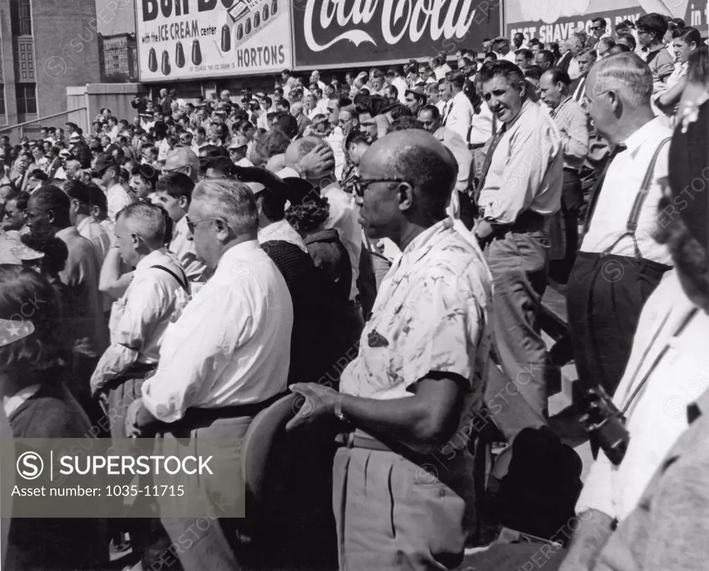 New York, New York:  September 29, 1955. Fans at Yankee Stadium stand for the National Anthem at the start of the second game of the 1955 World Series between the Yankees and the Brooklyn Dodgers.