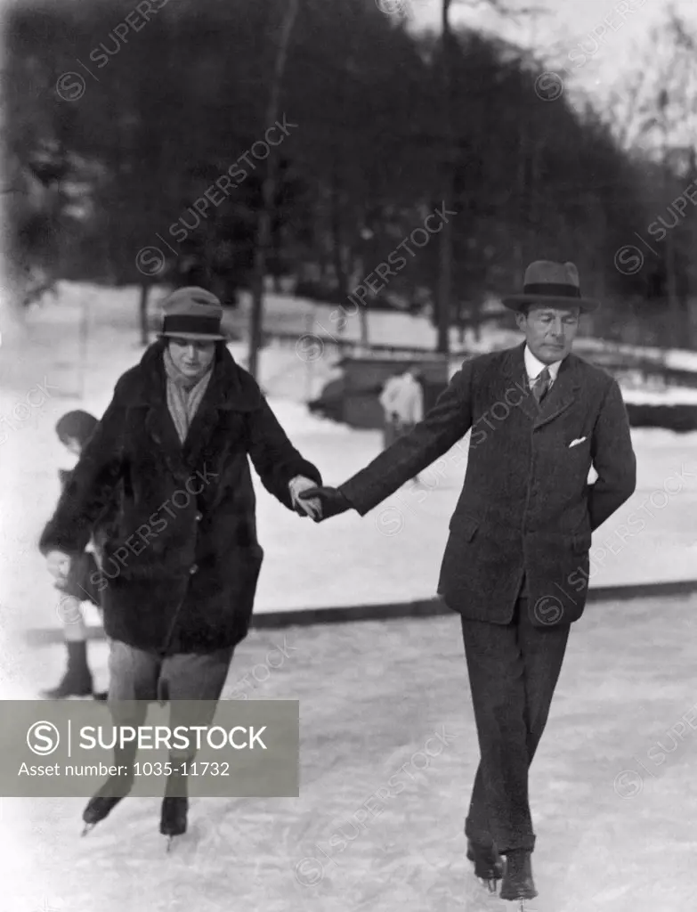 Tuxedo, New York: c. 1923. A New York society couple from the upper East side  enjoys an ice skating outing in Tuxedo.