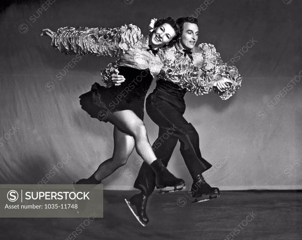 San Francisco, California:  August 26, 1940. Ice Follies stars Bruce Mapes and Evelyn Chandler show their style in this dynamic photo.