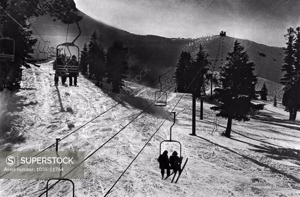 Squaw Valley, California:  c. 1966. The criss-cross of the lift lines and the well-worn tracks below highlight this photo of two of Squaw Valley's most popular lifts.