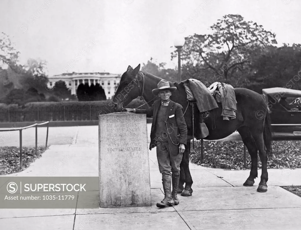 Washington, D.C.:  November 4, 1927. On April 1, 1925, Frank Heath of Silver Springs, Maryland, began a horseback tour of every state in the Union. Today he finished his ride, having ridden the same horse for 11,387 miles. Here he is at the Zero Milestone in front of the White House.