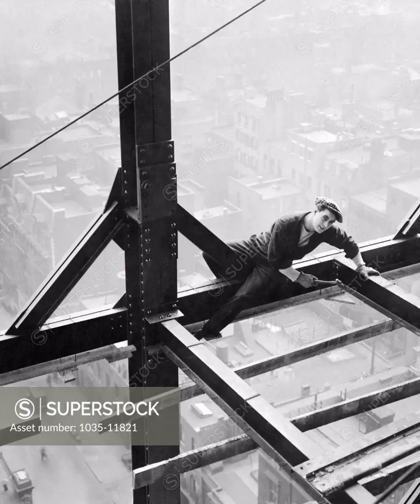 New York, New York:  1917. A man working on a girder on a sky scraper in a scene from the Fox Film, 'The Pride Of New York'.