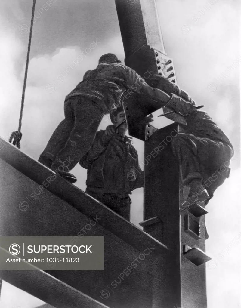 New York, New York:  c. 1922. Workers putting a steel beam into place in the construction of a New York skyscraper.
