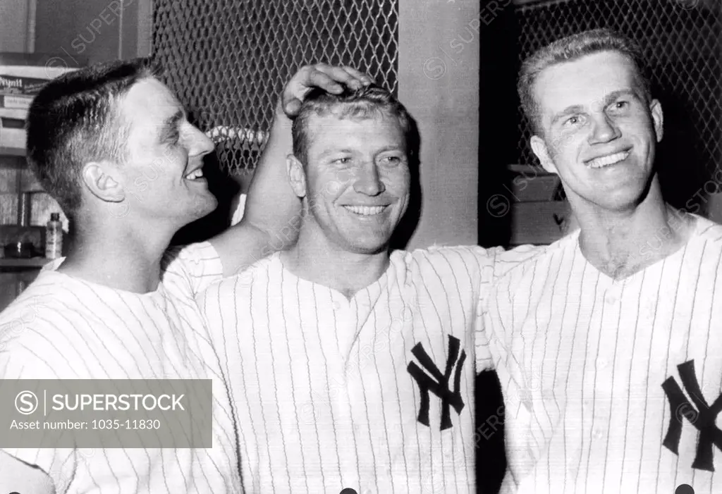 New York, New York:  July 2, 1961. Tony Kubek, Mickey Mantle, and Roger Maris celebrate a victory over the Washington Senators in the Yankee Stadium clubhouse. Maris hit one home run, and Mantle hit two in the game.