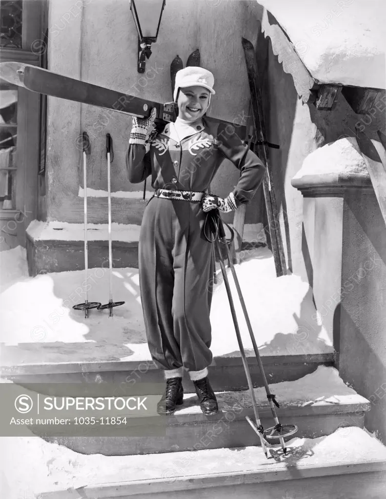 California:  c. 1936. World champion ice skater Sonja Henie poses with her ski gear.