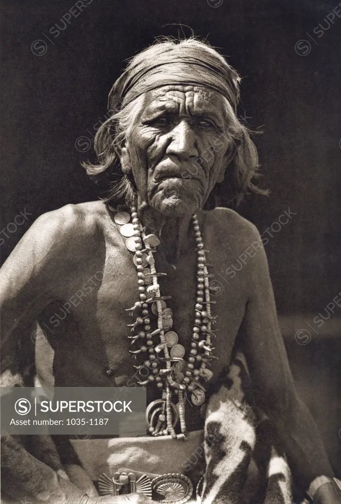 Close-up of a Native American man wearing traditional jewelry