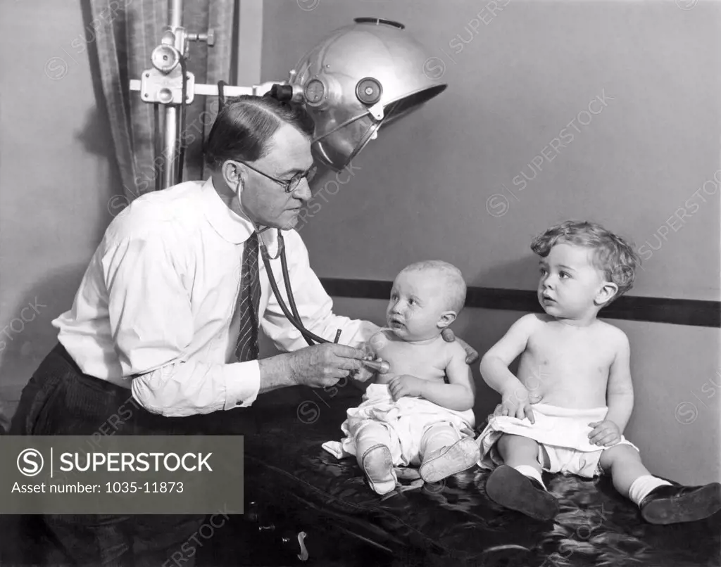 Chicago, Illinois: 1928. A doctor examines one of the entries into the first baby contest held by the Chicago chapter of the members of the Tribe of Ben Hur.