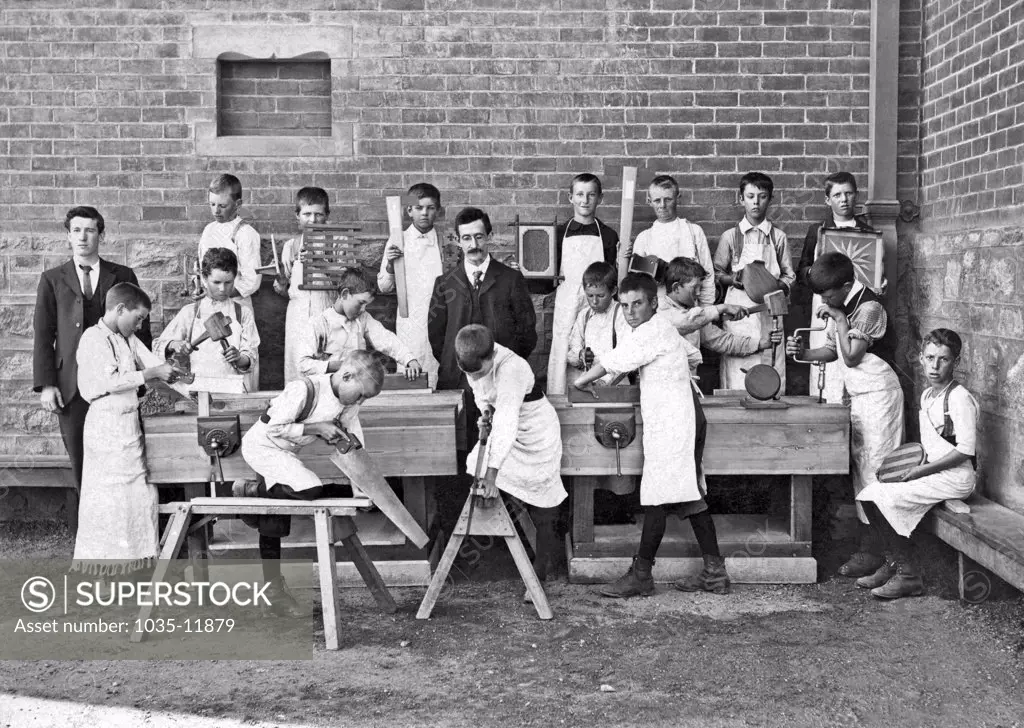 United States: c. 1890. A woodworking class in a school.