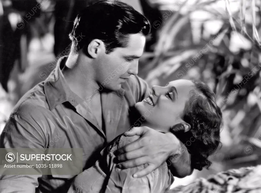 Hollywood, California:  1934. Marion Burns and Kane Richmond became so involved in their roles in 'Devil Tiger' that they just announced their marriage to each other.