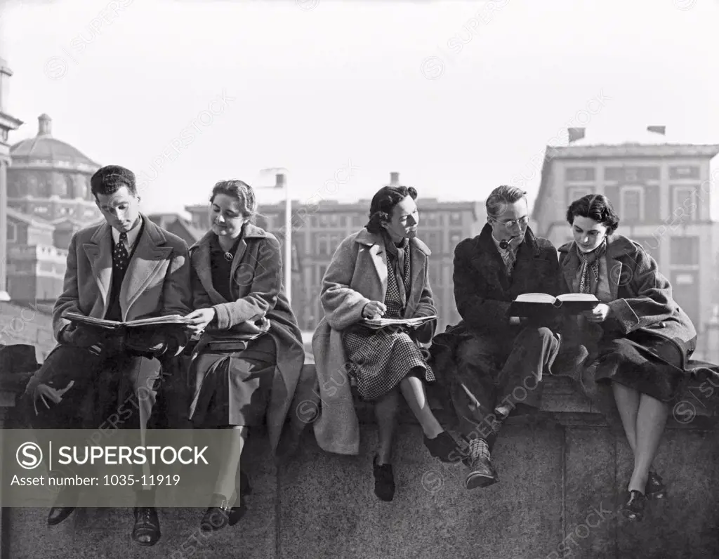 New York, New York:  c. 1938. Columbia University students reviewing notes and studying on a wall outside.