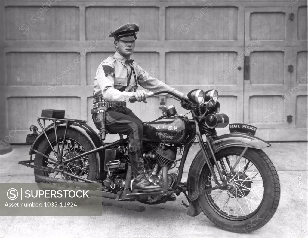 New Jersey:  1930. Trooper Haley of the New Jersey State Police poses on his Harley Davidson motorcycle.