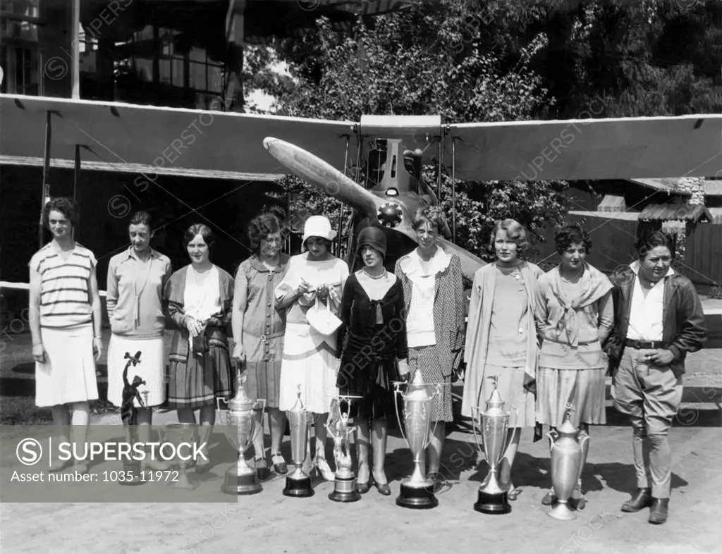 Los Angeles, California:  1929. Women flyers assembled at the Breakfast Club for the start of the first National Women's Air Derby from Clover Field in Santa Monica, to Cleveland, Ohio. Left to Right: Louise Thaden, Bobbie Trout, Patty Willis, Marvel Crosson, Blanche Noyes, Vera Dawn Walker, Amelia Earhart, Marjorie Crawford, Ruth Elder, Florence Lowe Barnes. Louise Thaden finished first, Earhart was third.