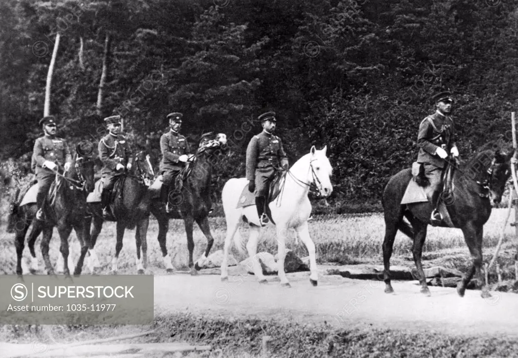 Fukui Prefecture, Japan: November 7, 1933. Emperor Hirohito of Japan, mounted on his favorite white horse, 'Snow Drift', as he directed the annual war maneuvers in western Japan.