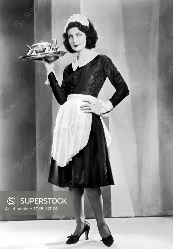 Hollywood, California:  c. 1920. A waitress with a serving tray, possibly in a silent movie.