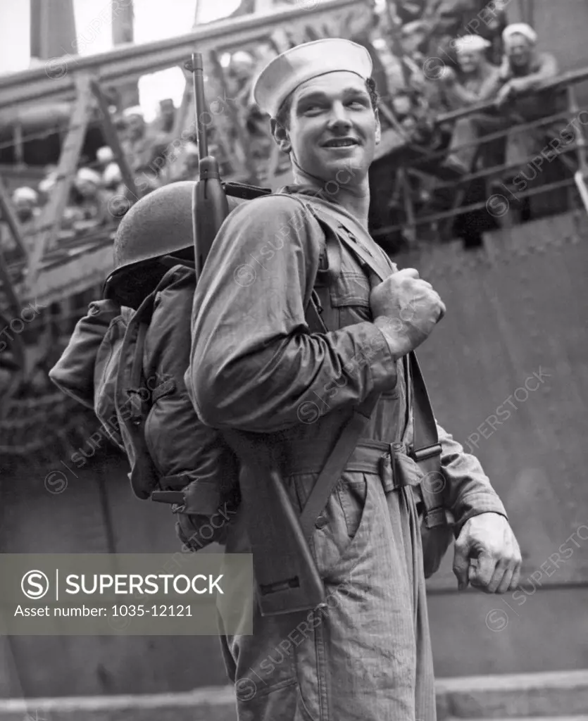 Davisville, Rhode Island:   December 26, 1943. This Navy Seabee is heading off for duty in the South Pacific. The Seabees were founded here two years ago on December 28, 1941, ready to work or fight or both.