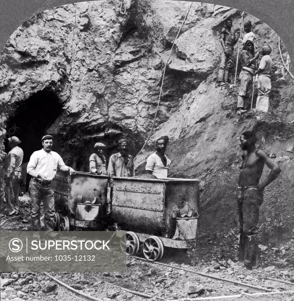 Kimberley, South Africa: c. 1900. Native black workers taking out the diamondferous blue earth that contains the diamonds in a mine at Kimberley in South Africa.