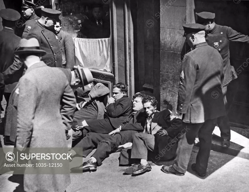 New York, New York:  April 27, 1933. Lying on the street are some of the injured workers after men armed with guns, knives, and lead pipes raided a meeting of the Needle Trade Workers on West 26th Street, leaving one dead and sixteen injured.