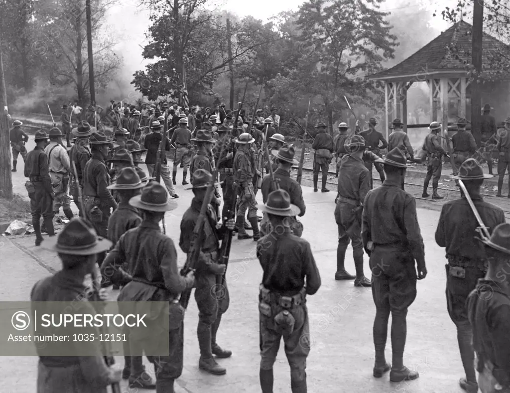 Greenville, South Carolina:  September 8, 1934. National Guardsmen with fixed bayonets route strikers at the Woodside Mill following disorders in connection with the general textile workers strike.