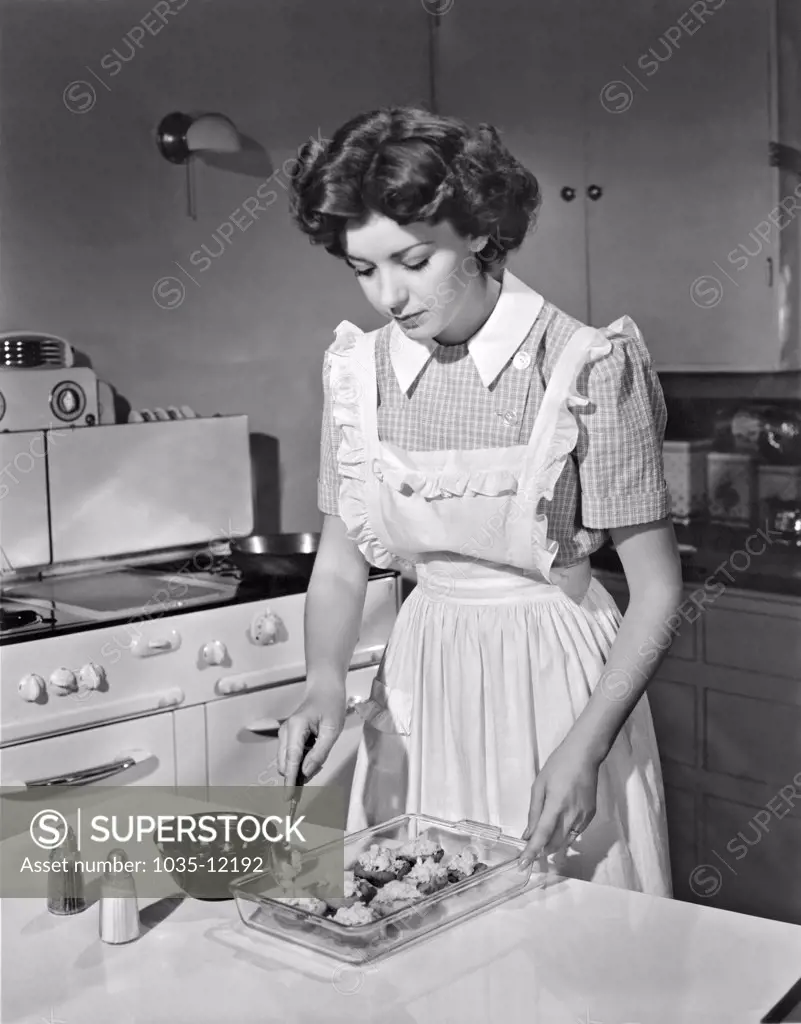 Hollywood, California:  1942. Actress Marsha Hunt prepares summer squash in her kitchen. She was blacklisted during the 1940's and 50's for her First Amendment stands.