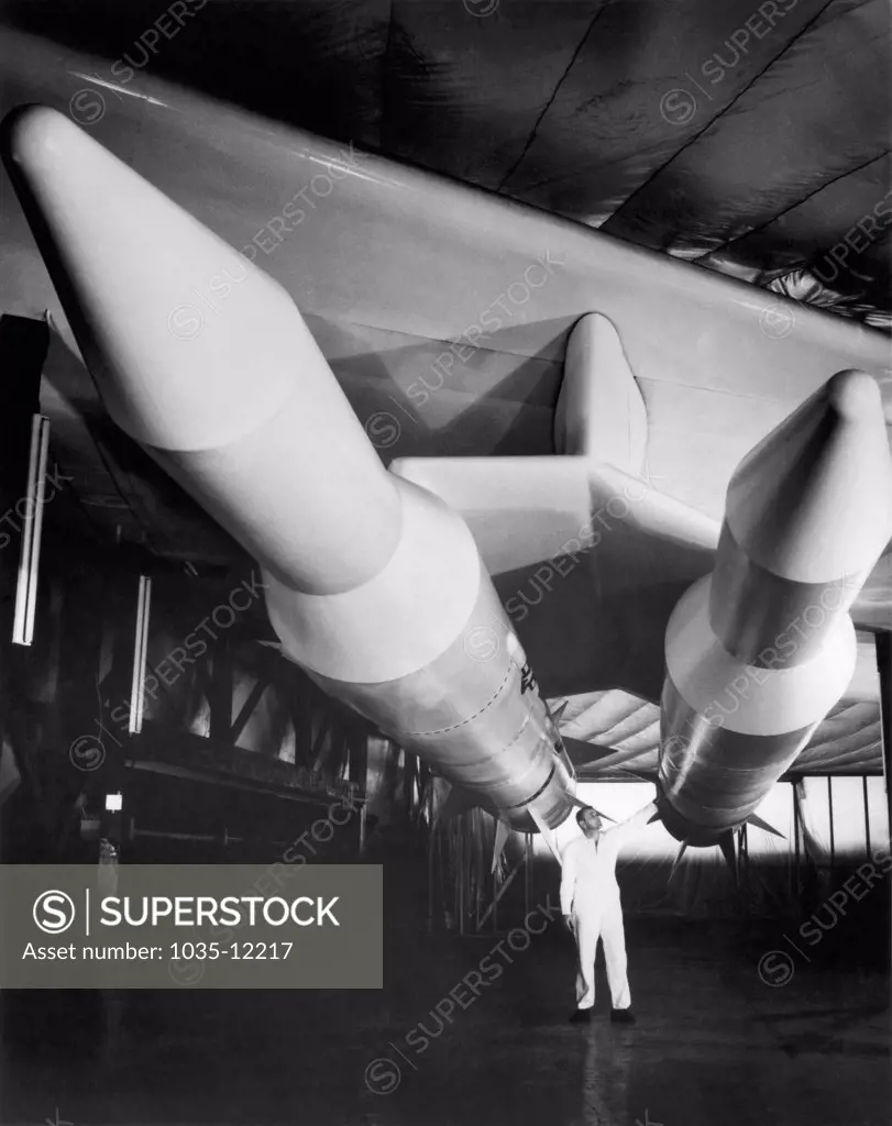 Wichita, Kansas:  1959.  Test models of Douglas Aircraft Skybolt missiles nestle under a B-52 wing at Boeing Aircraft's Wichita Division. They were to be hypersonic air to surface ballistic missiles with nuclear capability, but were eventually scrapped in favor of the newly developed submarine based Polaris missile in 1962, by Robert McNamara, Secretary of Defense under President John Kennedy