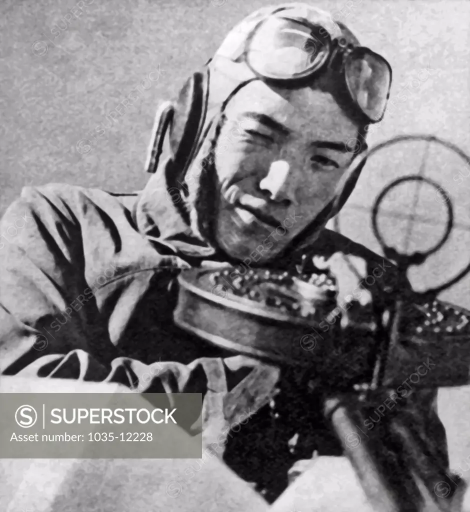 Japan:  1941. A Japanese pilot looking through a gun sight.
