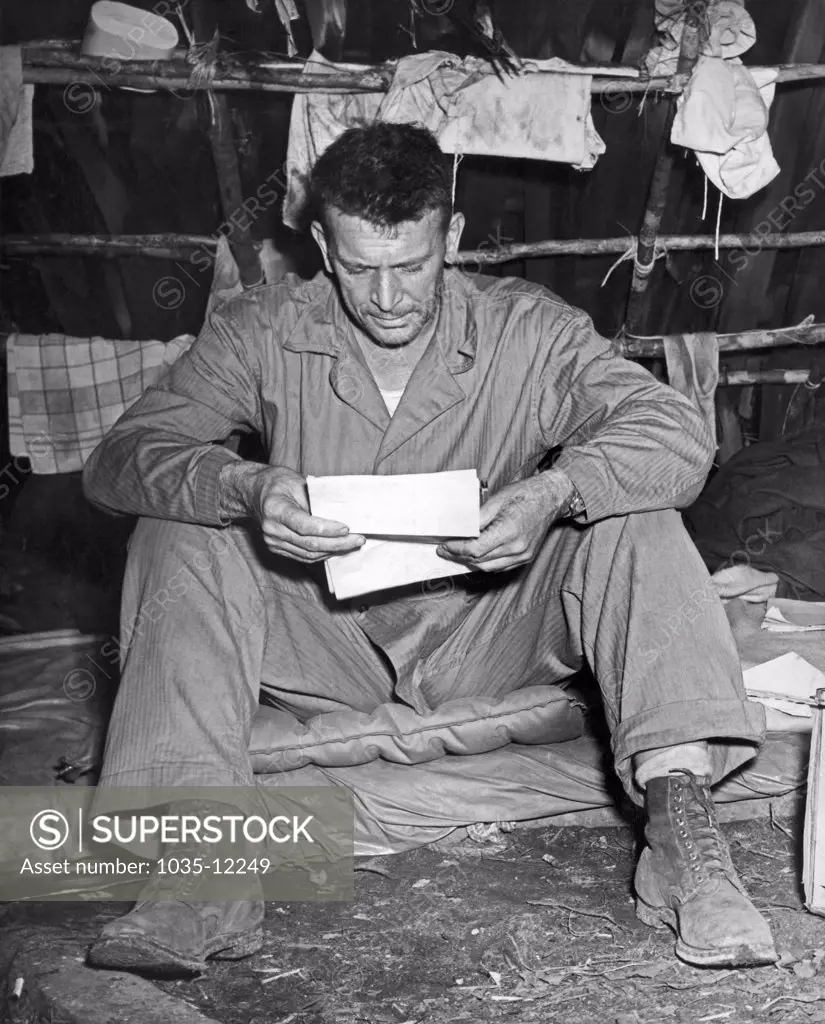 Enogai Inlet, New Georgia Islands, September, 1943. Col. Harry Liversedge,  Commanding Officer of the Marine Raiders, reads his first letter from home since he went into action. Regarded as one of the greatest combat leaders in Marine Corps history, in 1945 he led his Combat Team 28 to the top of Mount Suribachi on Iwo Jima, an event made famous by Joe Rosenthal's iconic image of the flag being raised by five Marines and a Navy medic.