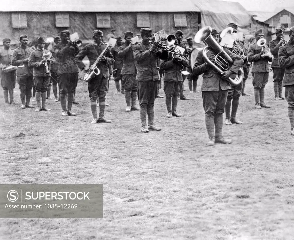 France:  c. 1918. Members of the 369th Infantry Regiment band under the direction of Lt. James Reese Europe. The 369th was also known as the 'Harlem Hellfighters'.