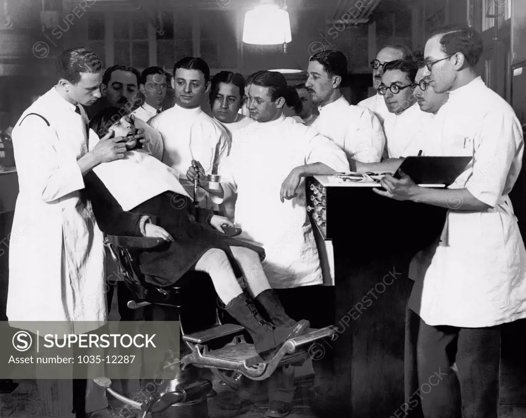New York, New York:  January 12, 1927 Dr. Krasny of New York University's Children's Dental Clinic demonstrating orthodontia on a ten year old child.