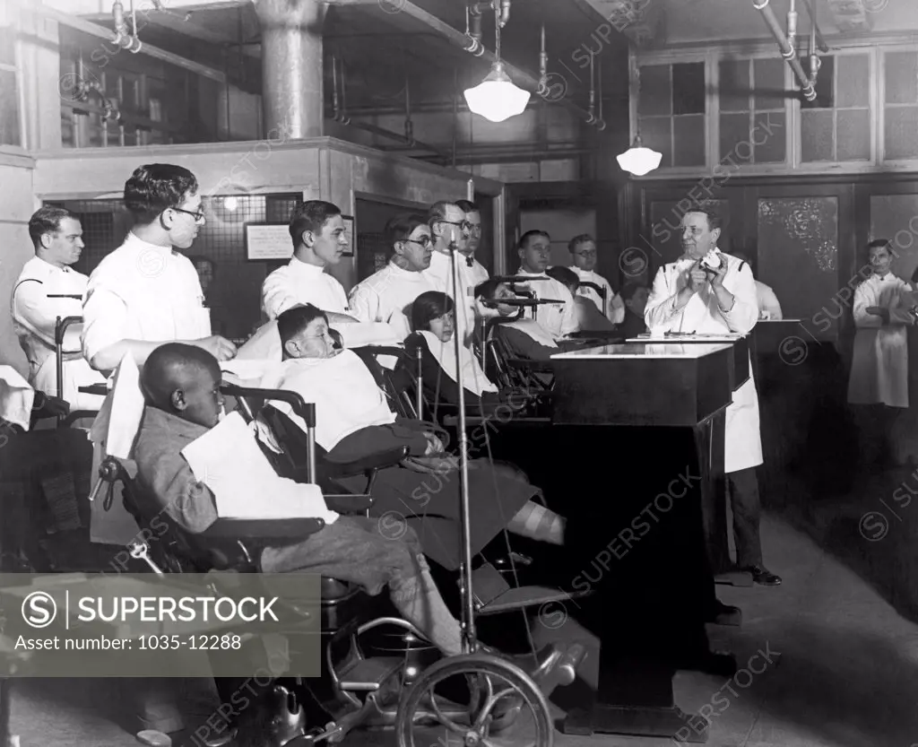 New York, New York:  January 14, 1927 Professor Abram Hoffmann of New York University's Children's Dental Clinic demonstrating orthodontia to students.