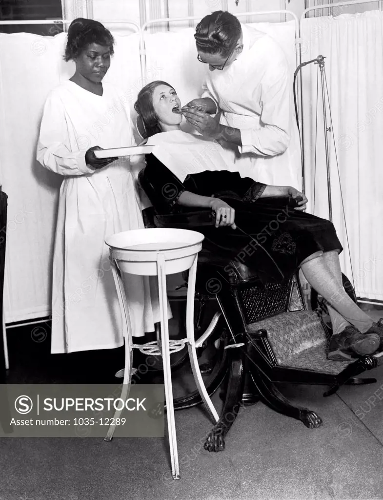 New York, New York:  January 19, 1925 The North Harlem Dental Clinic of the NY Tuberculosis Association provides dental care for those who cannot otherwise afford it. Here is a patient being treated.