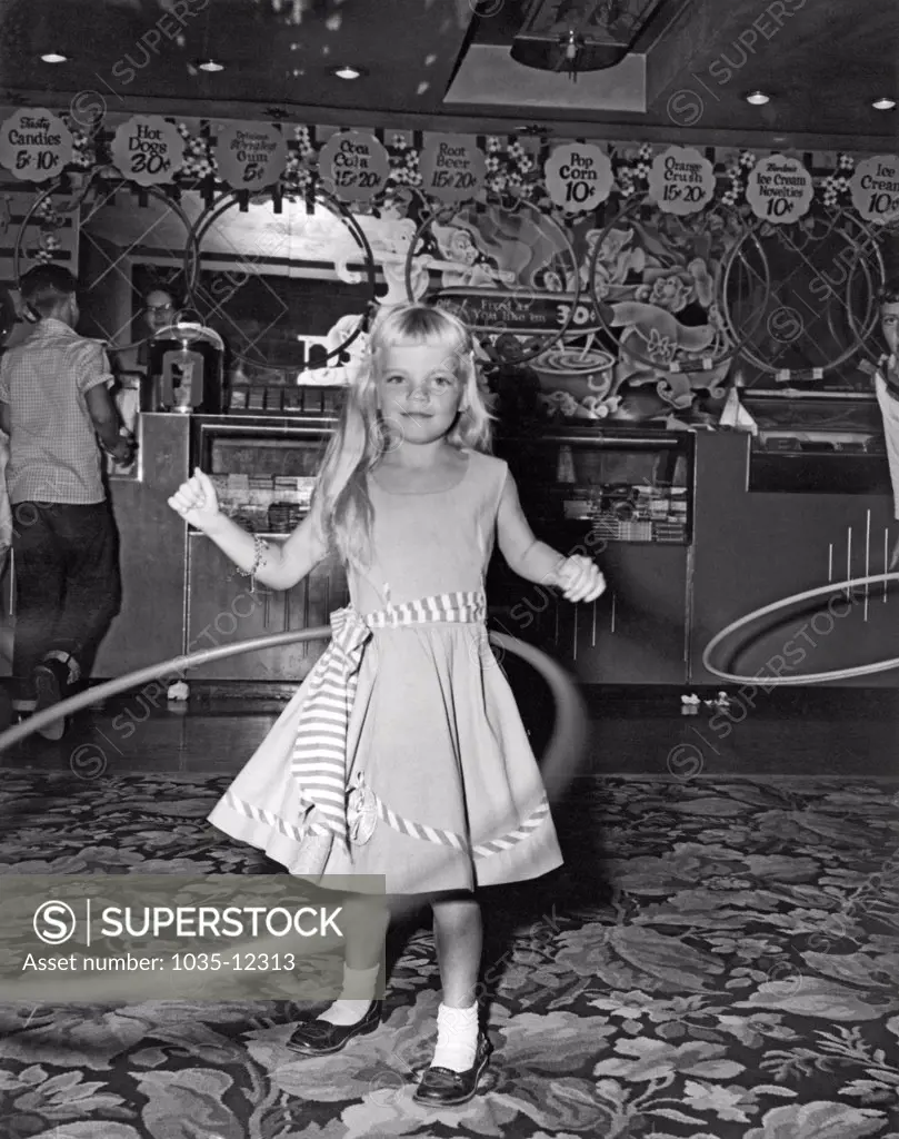United States:  1958. The hula hoop craze sweeps the country. Over 100 million were sold in the United States in the first year. This contest was held in a movie theater lobby, back when popcorn cost a dime and only came in one size.